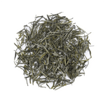 My Store’s Huangshan Maofeng Green Tea leaves are displayed in a circular pile on a white background, highlighting this famed Chinese tea known for its delicate flavor and wellness benefits.
