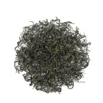 A circular pile of loose Biluochun Green Tea by My Store is displayed on a white background, showcasing its vibrant color and antioxidant-rich quality.