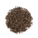 A circular pile of My Store Jin Jun Mei Black Tea loose leaves with golden tips, shown on a white background.